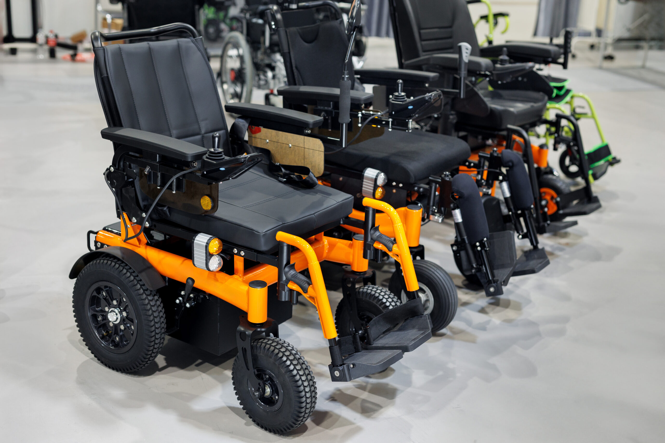 Wheelchairs With An Electric Motor In A Store Or At An Exhibition.